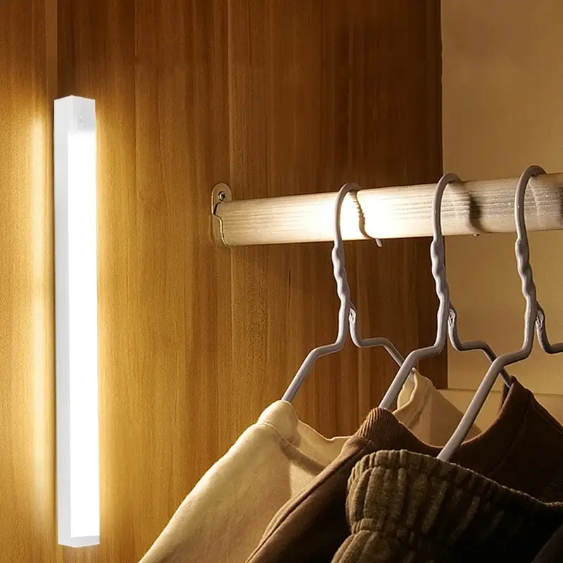 Vertical magnetic LED sensor light installed inside a wooden wardrobe.