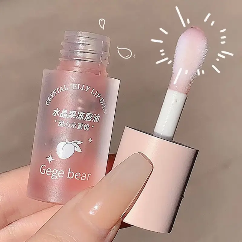 Close up of Gege Bear Crystal Jelly Lip Oil thick wand applicator and frosted bottle.