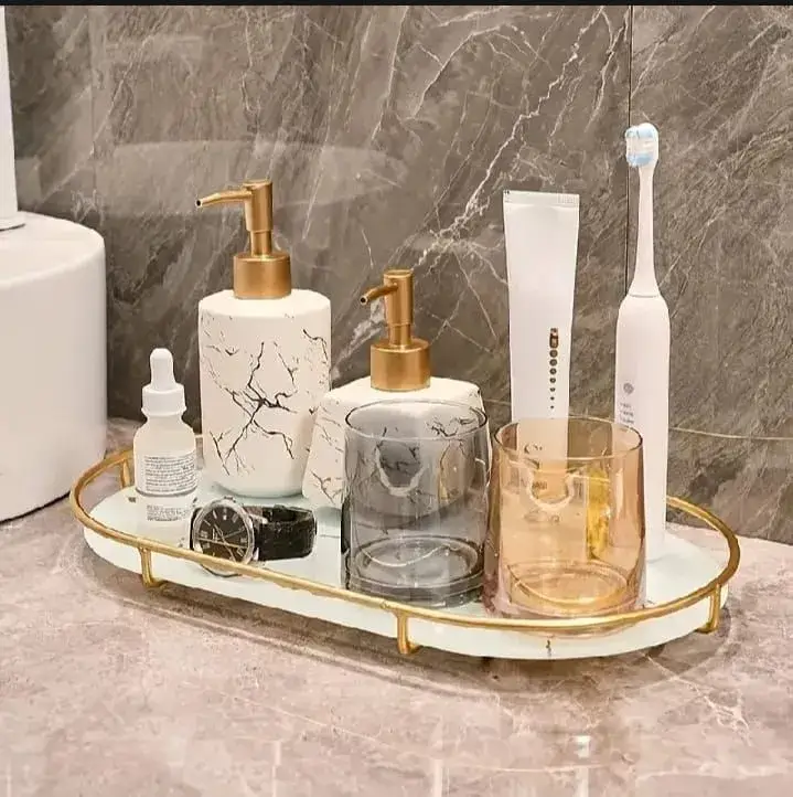 Luxurious gold and marble 3-tier makeup organizer on a dressing table