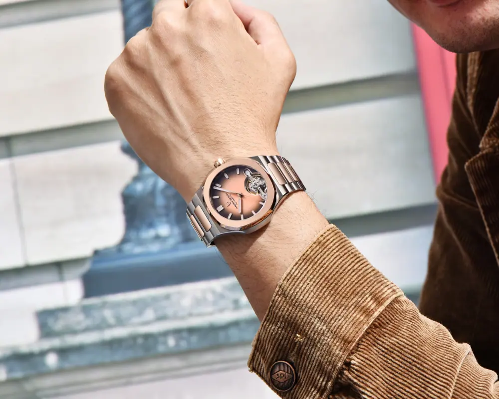 A man wearing the Pagani Design rose gold skeleton watch, paired with a stylish brown corduroy jacket.