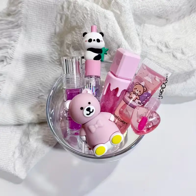 Pink-themed bear and panda lip makeup set displayed in a glass bowl with soft aesthetic lighting.