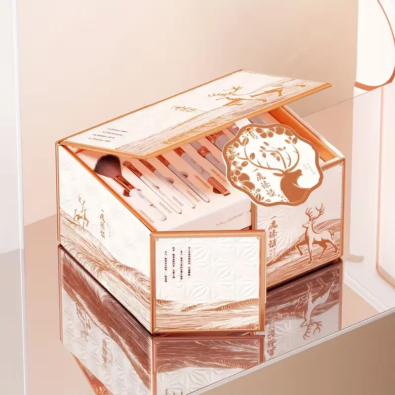 Closed view of the premium white and gold embossed beauty gift box featuring artistic deer illustrations.