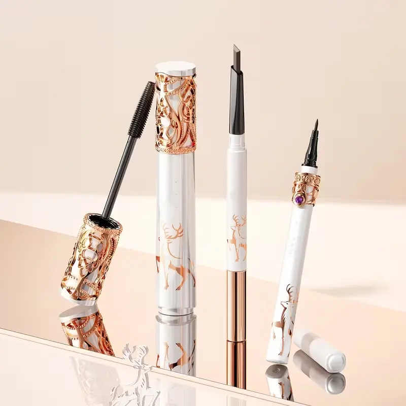Luxurious eye makeup trio including mascara, liquid eyeliner, and eyebrow pencil with intricate gold detailing.
