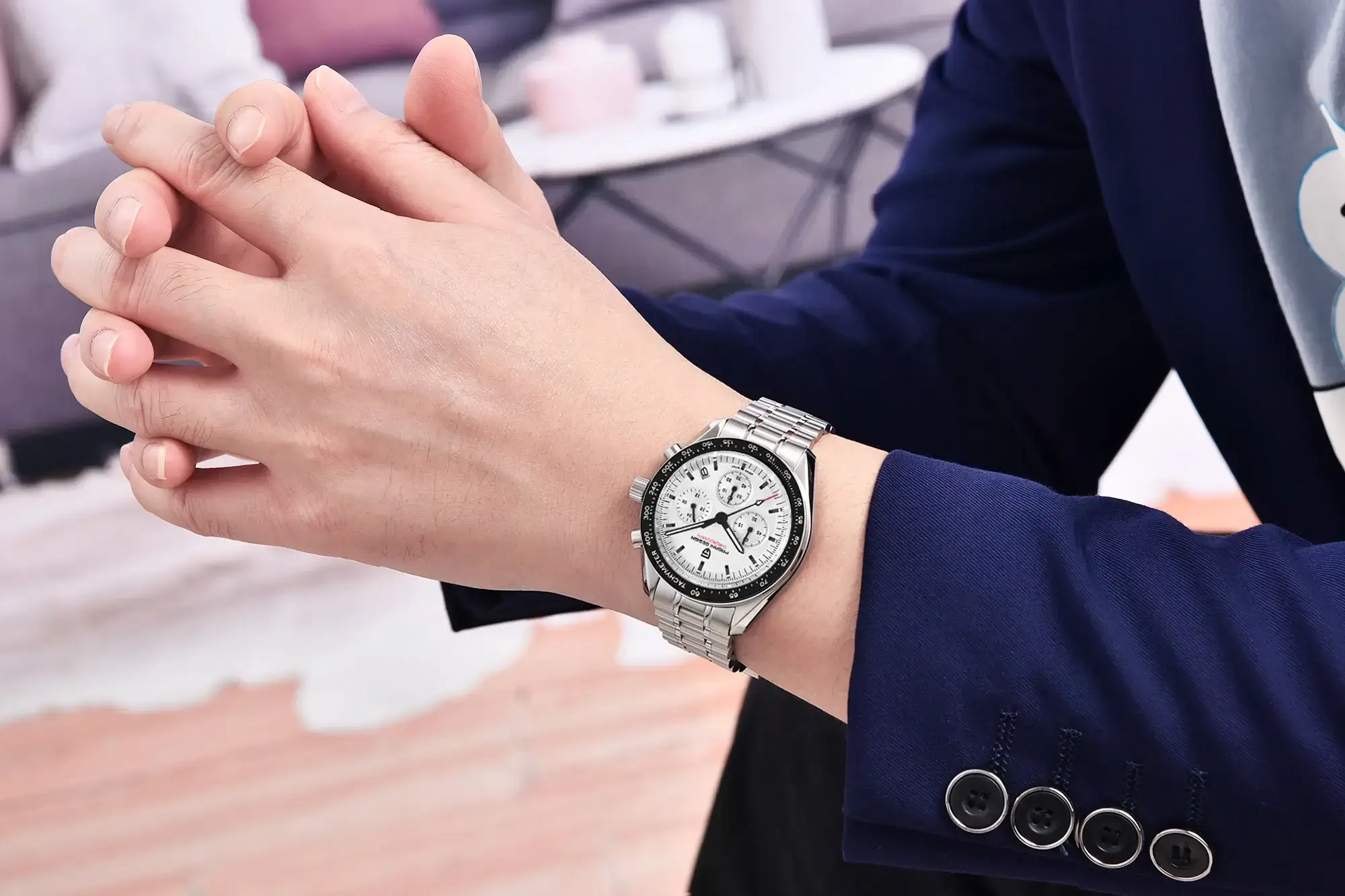 Professional wrist shot of the Pagani Design PD-1701 white dial 'Panda' chronograph worn with a navy blazer.