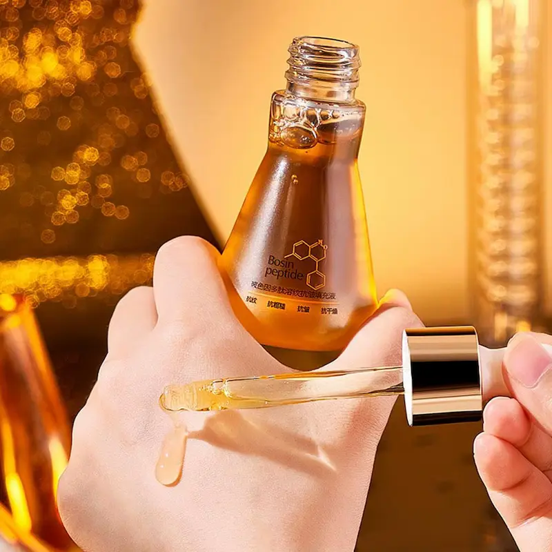 Applying anti-aging polypeptide face serum droplet on hand for skin absorption test.