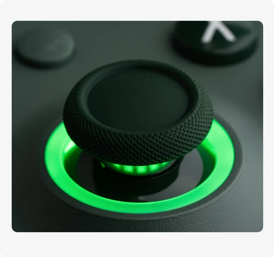 Macro close-up of the Hall Effect joystick with a glowing green RGB ring.