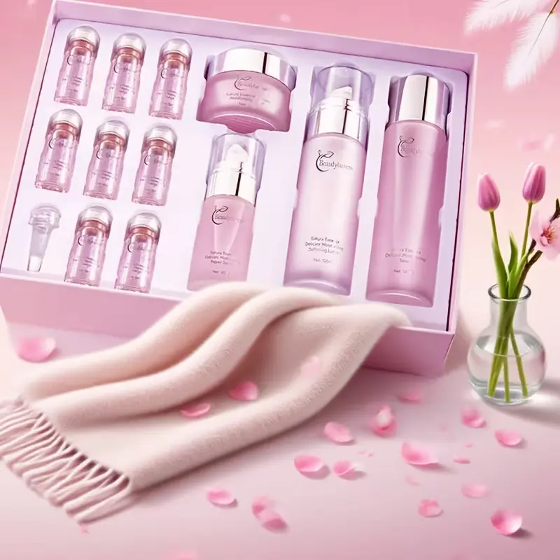 An open pink luxury gift box containing the full 12-piece Sakura Serum Skincare Set, including toner, serum, lotion, cream, and essence vials.