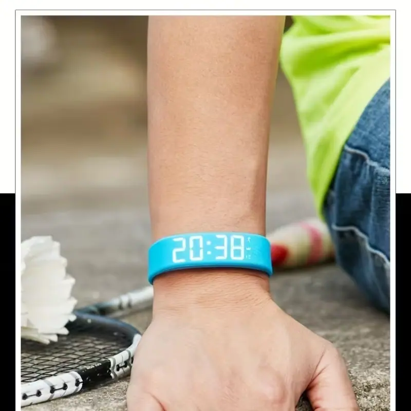 A person wearing a sky blue minimalist digital watch while sitting outdoors next to a badminton racket