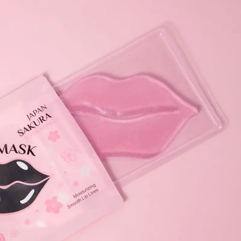 Opening a single packet of pink gel lip patch for hydrating lip care treatment.