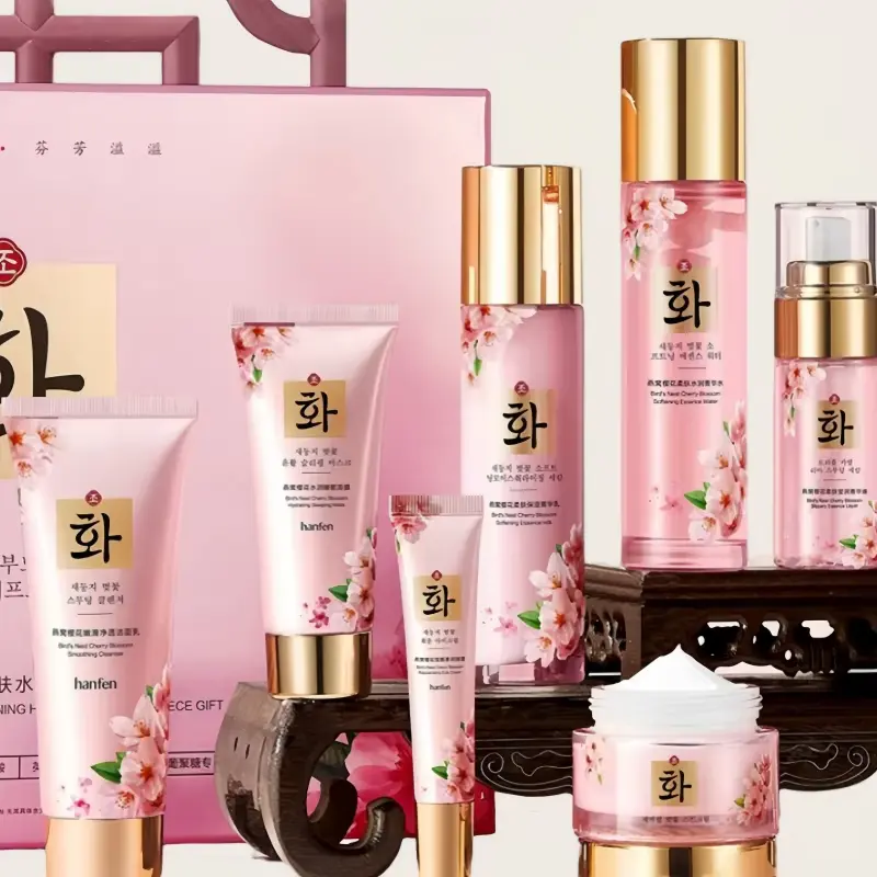 Close-up of the smooth white texture of Sakura face cream with the full product lineup in the background.