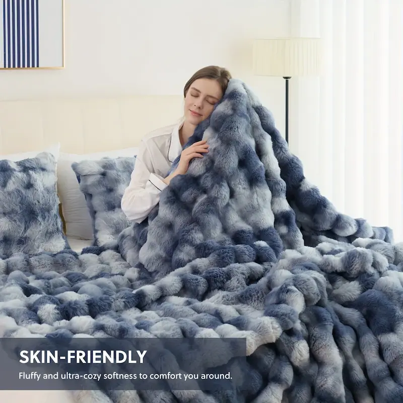 A woman enjoying the ultra-soft and skin-friendly texture of a blue patterned fleece blanket.