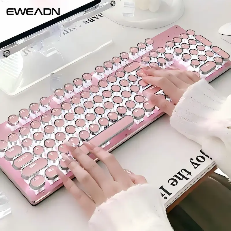 Hands typing on the pink retro typewriter style keys during an EWEADN TK950 Keyboard Review.
