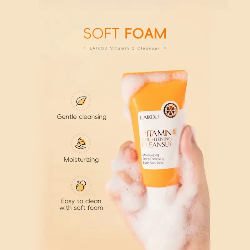 A hand holding the LAIKOU Vitamin C cleanser tube covered in soft, rich white foam.