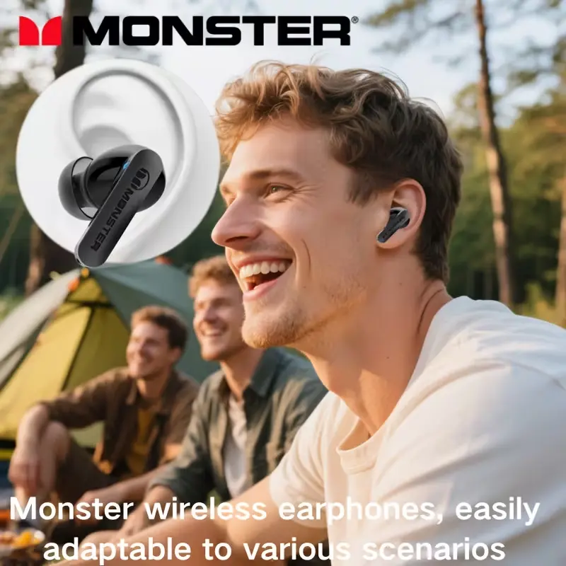 A happy man wearing Monster wireless earbuds while camping outdoors, demonstrating secure fit and comfort.