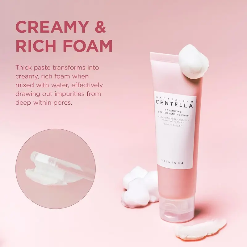 Close-up of the creamy white texture of the Poremizing Deep Cleansing Foam on a pink background.