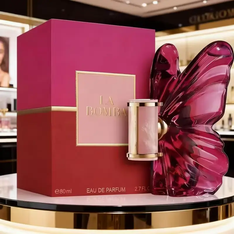 LA Bom b.A Review featuring the 2.7 oz Eau de Parfum bottle placed next to its red and pink luxury packaging box.