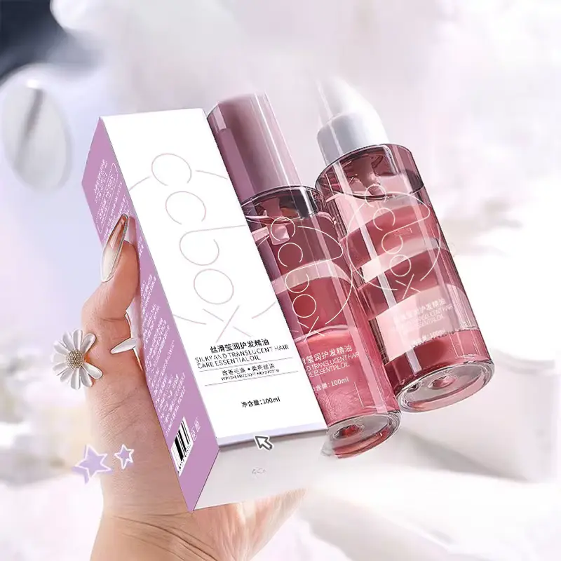 CCBOX 100ml hair care essential oil bottle held in hand next to its original box packaging.