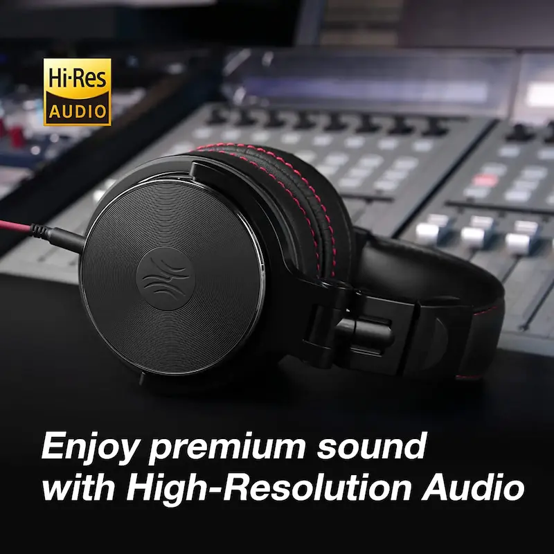 Black over-ear DJ headset placed on an audio mixing console board.