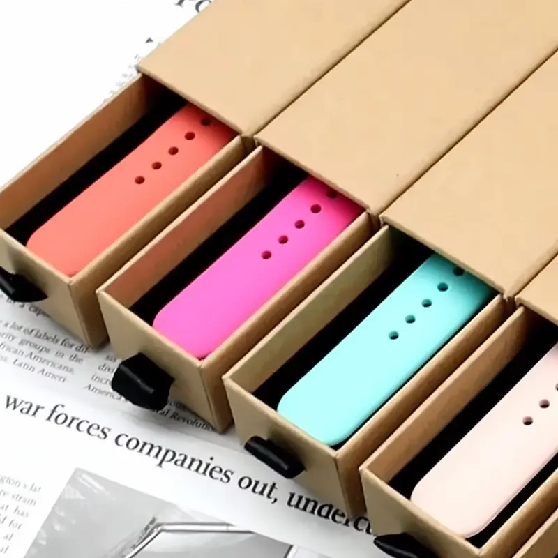Multiple colorful silicone watch bands neatly packed in premium kraft paper boxes.