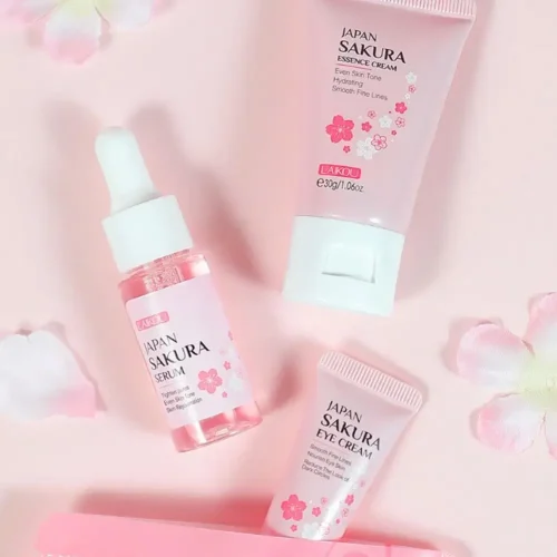 Flat lay of LAIKOU Sakura serum, eye cream, and essence on a pink floral background.